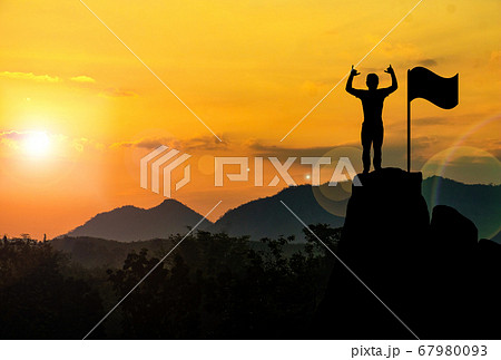 Silhouette photo.A man show hand and standing on cliff.A man happy and good feel for nature.lifestyle,freedom,He is see sun set.Photo concept achievement and Silhouette. Silhouette photo.A man show hand and standing on cliff.A man happy and good feel for nature.lifestyle,freedom,He is see sun set.Photo concept achievement and Silhouette. 67980093