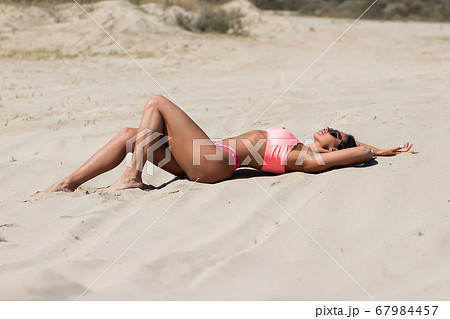 Stylish woman resting on beach Stylish woman resting on beach 67984457