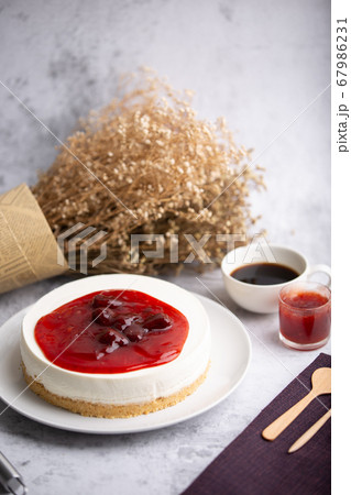 Ice box cheese cake with strawberry jam and a cup Ice box cheese cake with strawberry jam and a cup 67986231