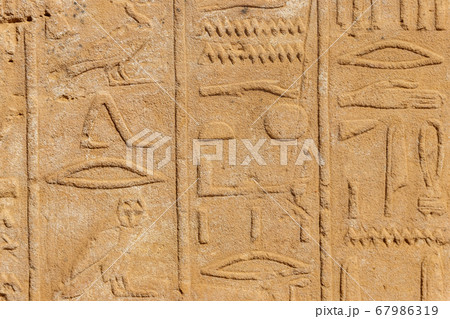 Ancient egyptian hieroglyphs on the wall in Karnak 67986319