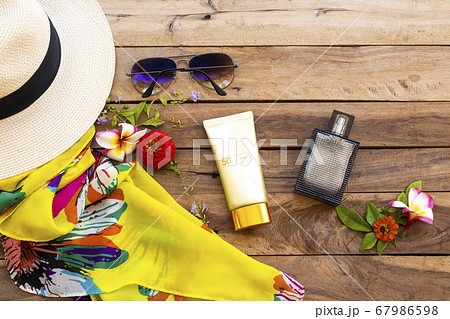 sunscreen spf50 cosmetics health care for skin face with hat ,sunglasses ,purfume ,yellow scarf and flowers of lifestyle woman sunscreen spf50 cosmetics health care for skin face with hat ,sunglasses ,purfume ,yellow scarf and flowers of lifestyle woman 67986598