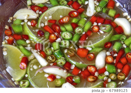 Fresh chilies cut into small pieces, put in a clear cup, seasoned with fish sauce, lemon, garlic to add flavor to Thai food every day. Fresh chilies cut into small pieces, put in a clear cup, seasoned with fish sauce, lemon, garlic to add flavor to Thai food every day. 67989125