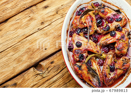 Chicken wings with cherries. 67989813