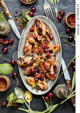 Chicken wings with cherries. 67989819