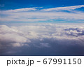 Aerial sky and fluffy clouds background. View from airplane porthole 67991150