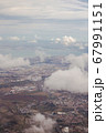 View from the porthole of an airplane. Clouds over Lisbon. 67991151