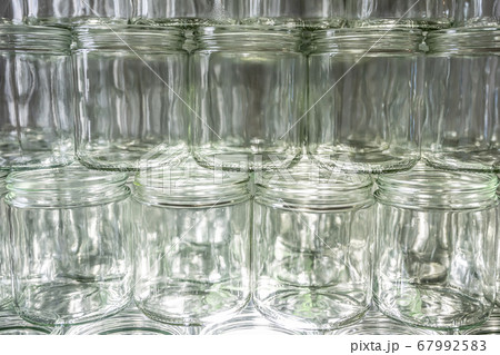 many glass jar empty glasses row for jam honey with lid caps abstract background bokeh many glass jar empty glasses row for jam honey with lid caps abstract background bokeh 67992583