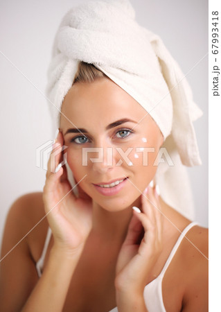 skin care and recovery.young girl with clean perfect skin. Blonde with natural touching her face. Spa 67993418