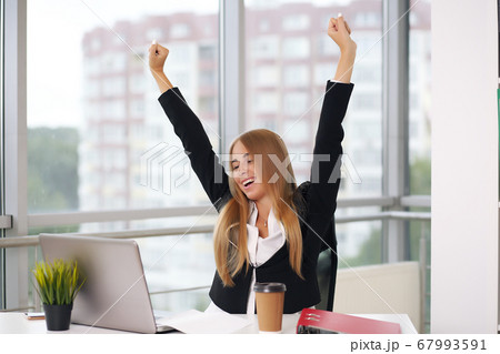 blonde in a suit rejoices, hands up, business lady, office blonde in a suit rejoices, hands up, business lady, office 67993591