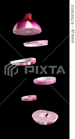 flying rings of sliced purple onion on black 67993603