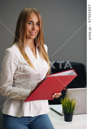 Focused woman working at her computer. Background for office startup Focused woman working at her computer. Background for office startup 67993607