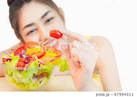 Young beautiful asian woman looking  a salad glass cup smile isolated on white background 67994011