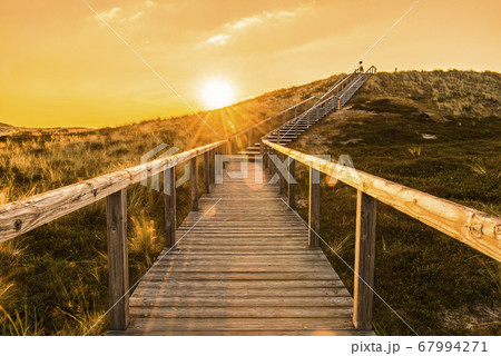 Sylt island wooden stairs at sunrise. Golden hour 67994271