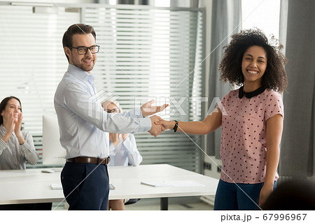 Executive introducing new employee, handshaking with businesswoman 67996967