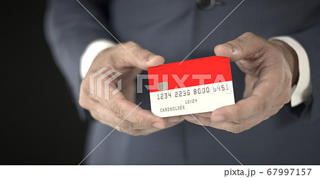 Businessman holding plastic bank card with printed flag of Indonesia, fictional numbers Businessman holding plastic bank card with printed flag of Indonesia, fictional numbers 67997157