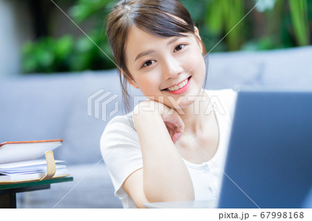 Woman using laptop Woman using laptop 67998168