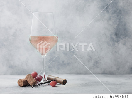 Glass of summer pink rose wine with grapes, corks Glass of summer pink rose wine with grapes, corks 67998631