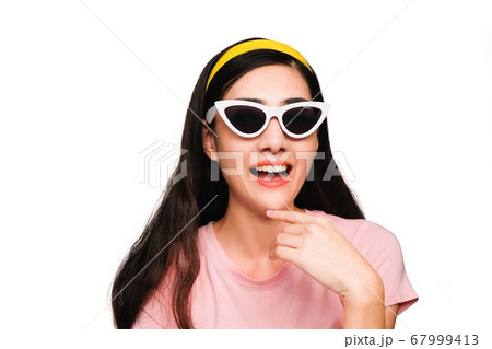 thinking,young beautiful asian woman in pink t-shirt wearing sunglasses,excited,surprised,smiling isolated on white background thinking,young beautiful asian woman in pink t-shirt wearing sunglasses,excited,surprised,smiling isolated on white background 67999413