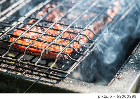 Juicy slices of meat with sauce prepare on fire Juicy slices of meat with sauce prepare on fire 68000899