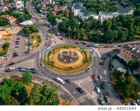 Aerial view of roundabout road with circular cars Aerial view of roundabout road with circular cars 68001694