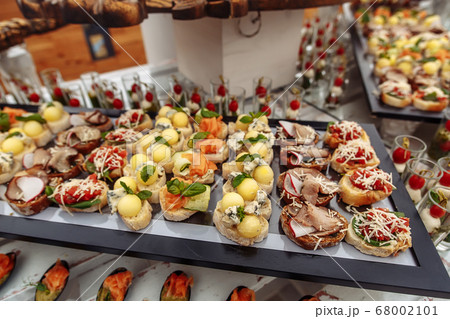 Different snacks on wooden tray near the bar 68002101
