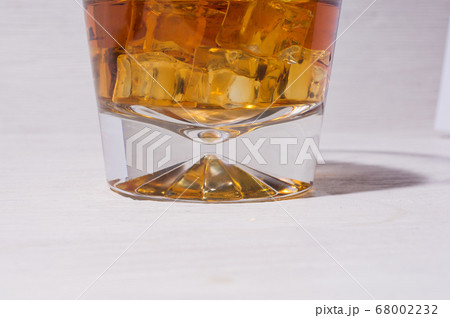 Glass of alcohol drinks with ice cubes on white Glass of alcohol drinks with ice cubes on white 68002232