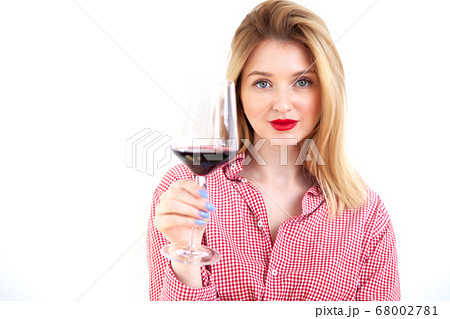 Young beautiful woman holding red wine glass on white background Young beautiful woman holding red wine glass on white background 68002781