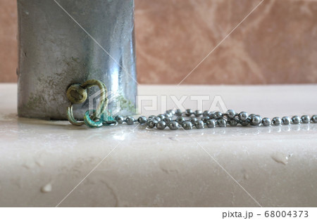 Calcium deposits on chain bathroom sink stopper 68004373