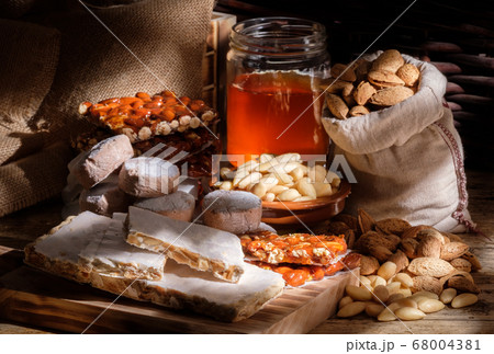 Slices of turron on the wooden board Slices of turron on the wooden board 68004381