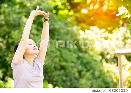 young Asian woman doing yoga fitness exercises in the nature park, young Asian woman doing yoga fitness exercises in the nature park, 68005030