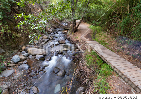 Pure water stream flowing over rocky mountain Pure water stream flowing over rocky mountain 68005863