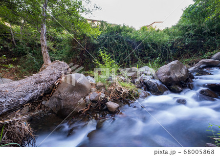 Pure water stream flowing over rocky mountain Pure water stream flowing over rocky mountain 68005868