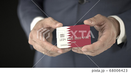 Businessman takes credit card with printed flag of Qatar, fictional numbers 68006423