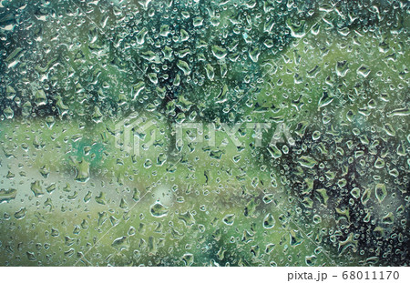 Dripping down drops of rain on glass 68011170