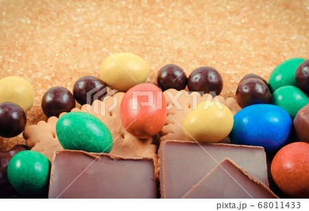 Natural brown cane sugar and candies with cookies. Natural brown cane sugar and candies with cookies. 68011433