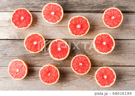 Grapefruit halves on wooden table. Top view 68016199