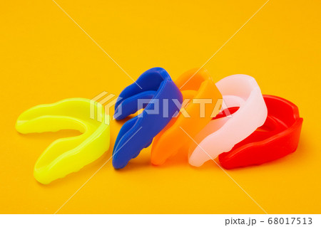five colored boxing mouth guards laid out in a row five colored boxing mouth guards laid out in a row 68017513