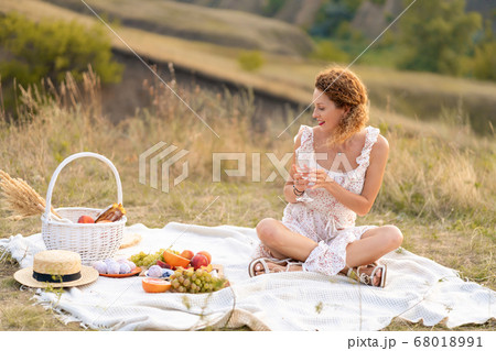 Beautiful girl on a picnic in a picturesque place. Beautiful girl on a picnic in a picturesque place. 68018991