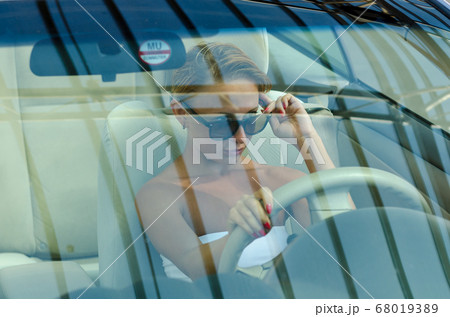 Woman driving a car Woman driving a car 68019389