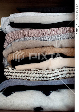 clothes neatly stacked in a closet 68019442
