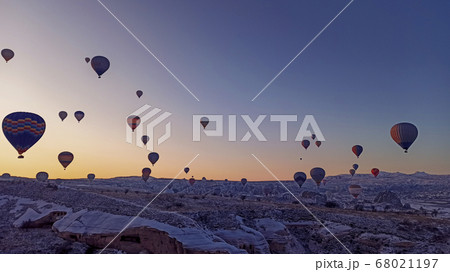 Colorful hot air balloons flying at the sunrise with rocky landscape in Cappadocia, Turkey Colorful hot air balloons flying at the sunrise with rocky landscape in Cappadocia, Turkey 68021197