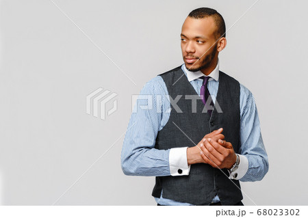 Studio shot of young African-American businessmanman over grey background Studio shot of young African-American businessmanman over grey background 68023302