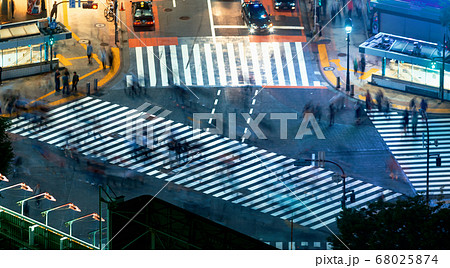 People and traffic cross the famous scramble intersection in Shibuya, Tokyo, Japan 68025874