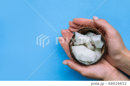 Halved fresh coconut and Coconut flesh on the blue background. Halved fresh coconut and Coconut flesh on the blue background. 68026652