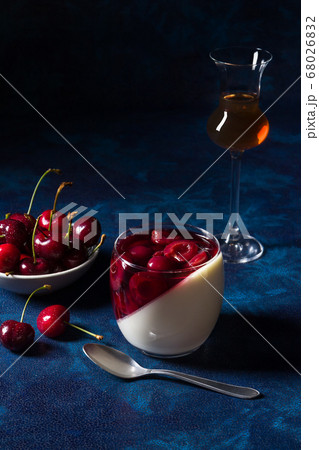 Panna cotta Italian traditional dessert with cherries poached in rum and honey syrup.  68026832