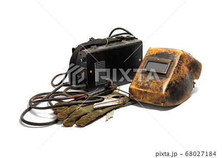 Welding mask with welding machine, protective gloves, and arc steel electrodes. Kit of used welding equipment on white background 68027184