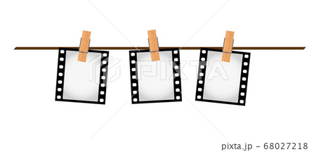 Three photo film slides on a rope with clothepins 68027218