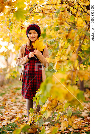 cheerful teenager girl in hat stand in autumn park cheerful teenager girl in hat stand in autumn park 68030500
