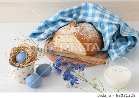 Breakfast with Easter symbols, traditional Czech pastry Mazanec, Pomlazka and eggs in blue style. 68031228