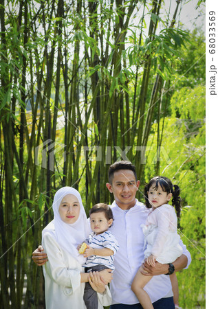 young parents spending time with their children at park during weekend 68033569